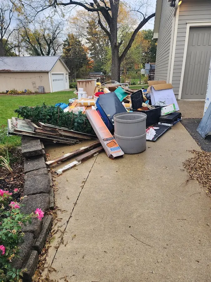 Dumpster being loaded with debris for Estate Cleanout Dumpster Rental in Edgewood
